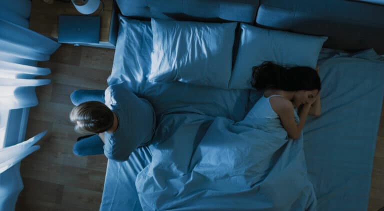 man awake suffering from sexual trauma